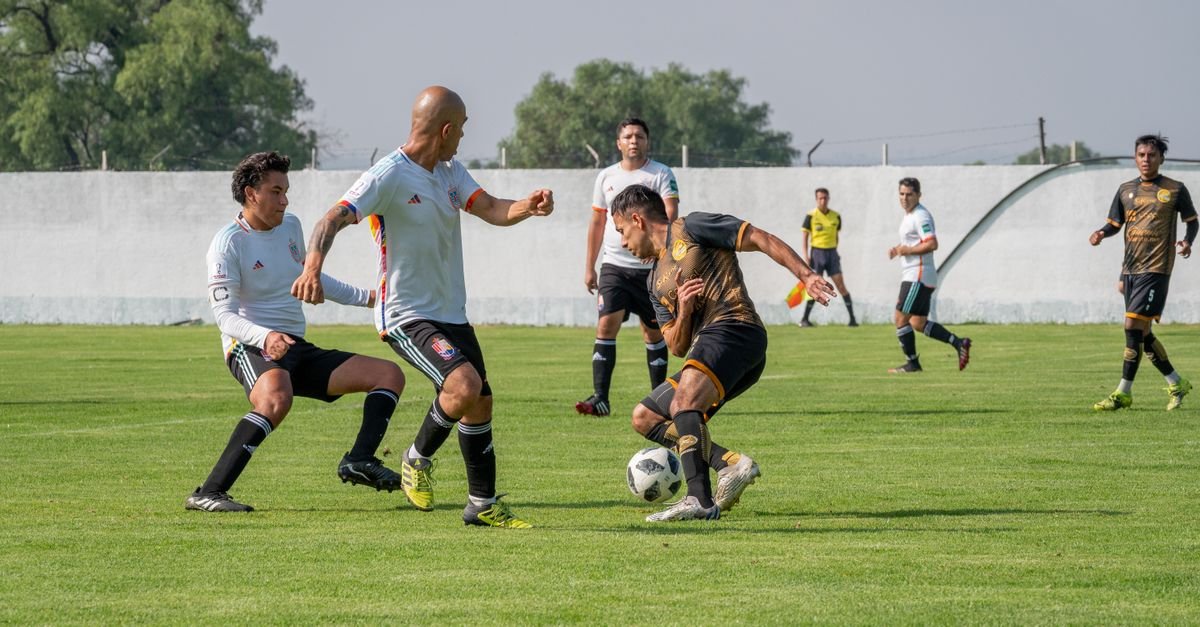 Dynamic soccer match featuring players in motion on a sunny outdoor field.