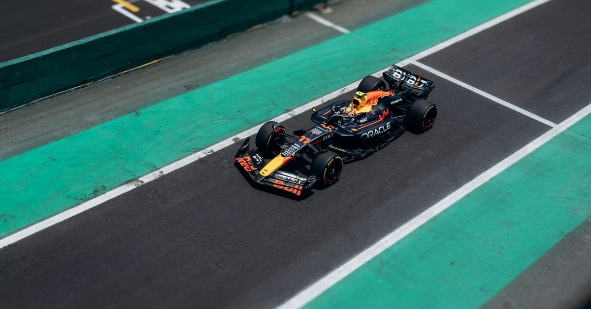 High-angle shot of a Formula One race car speeding on the track during a sunny day.