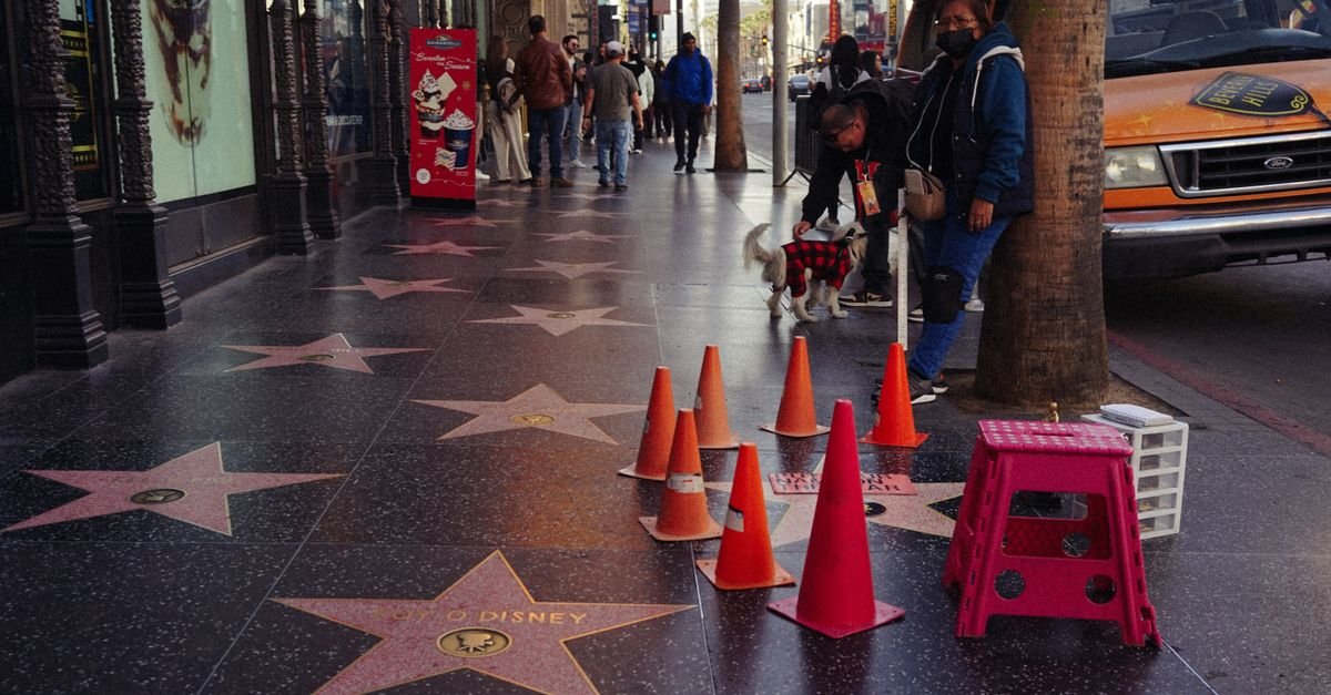 Vibrant day on the Hollywood Walk of Fame with stars and pedestrians.