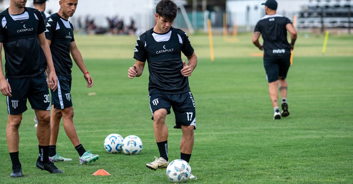 Young soccer players engaged in training on a grassy field with focus on foot skills.