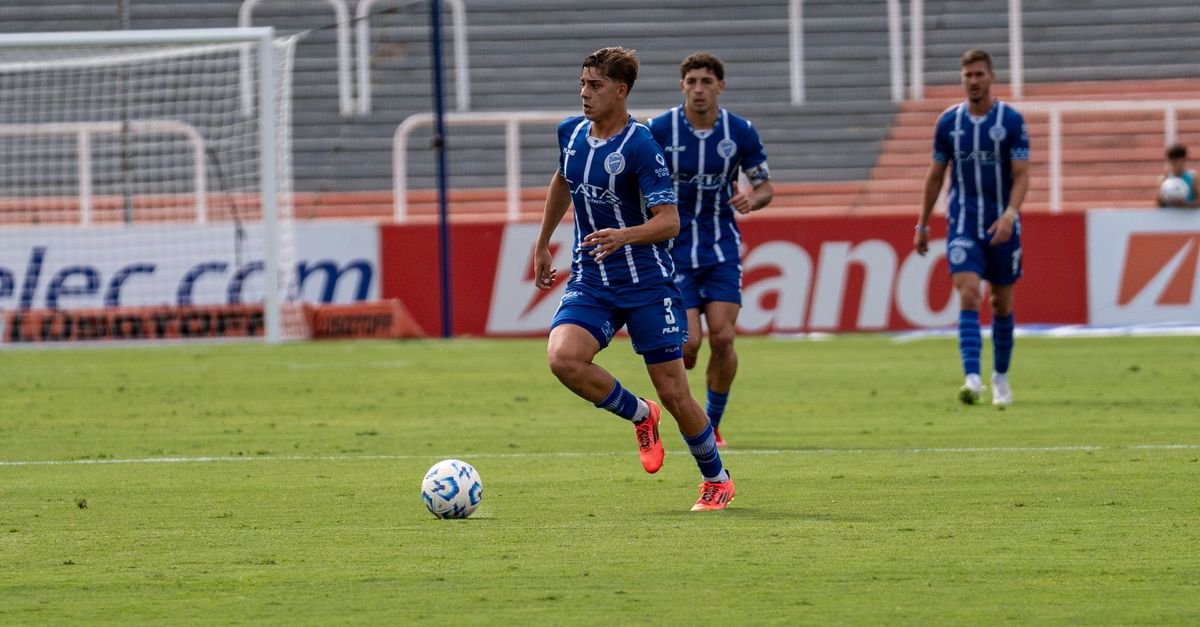 Exciting action shot of soccer players in blue jerseys during a match.