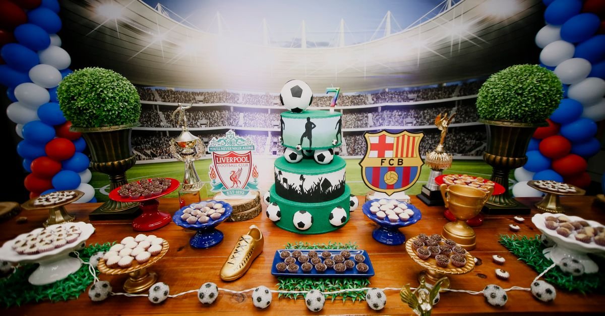Vibrant football-themed dessert table with cake, sweets, and decorations for a birthday party.