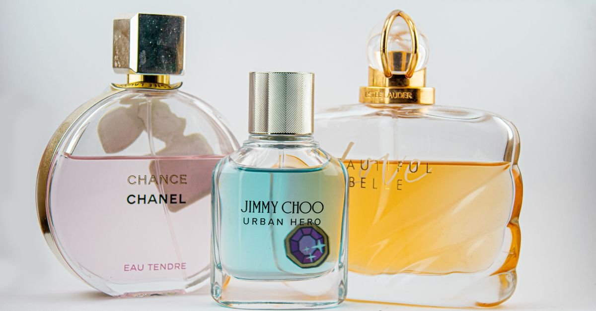 Elegant display of designer perfume bottles featuring Chanel, Jimmy Choo, and Estee Lauder.